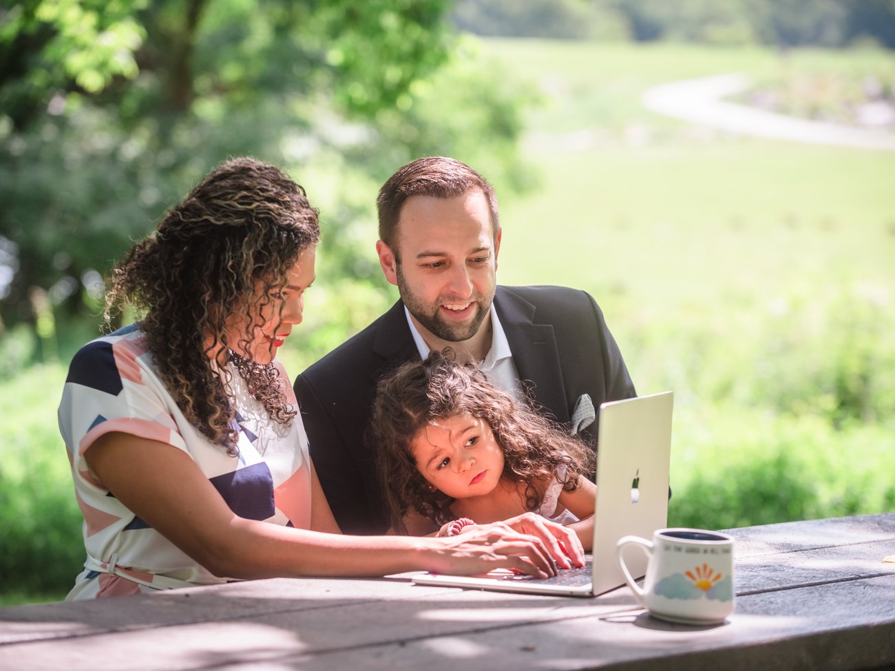 The founder of Your Path Marketing working on a laptop with family